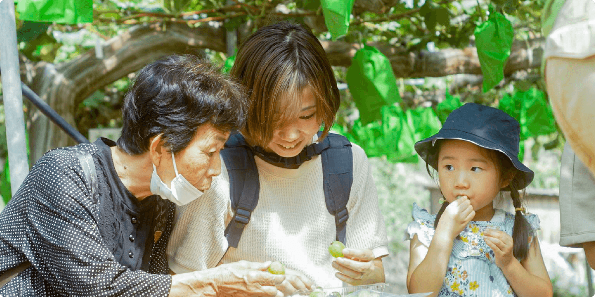 A family tasting grapes