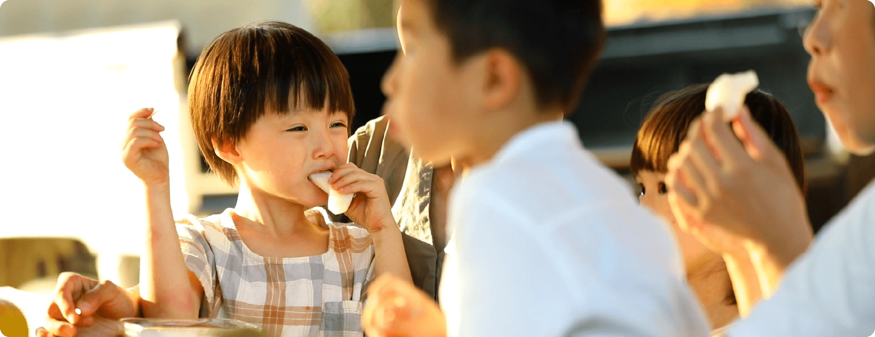 A child tasting a pear picking