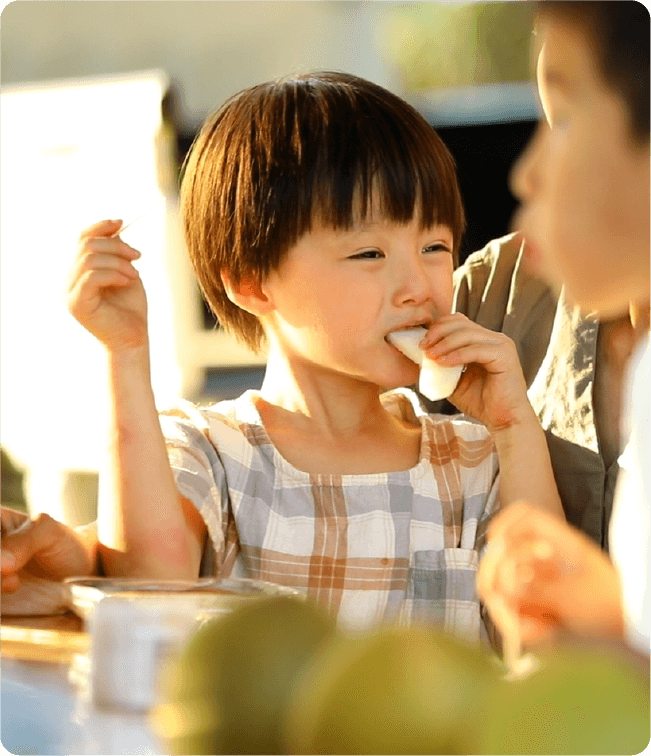 A child tasting a pear picking